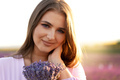 Young woman in dress holding bouquet of flowers standing in lavender field - PhotoDune Item for Sale