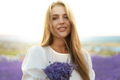 Close up portrait of a young woman holding bouquet of lavender whiile standing in lavender field - PhotoDune Item for Sale