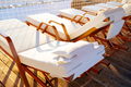 Empty deck chairs with white mattresses in resort hotel - PhotoDune Item for Sale