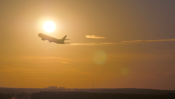 Airplane Takeoff at Sunset