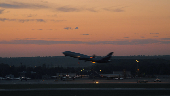 Airport with Plane Taking Off in the Dusk