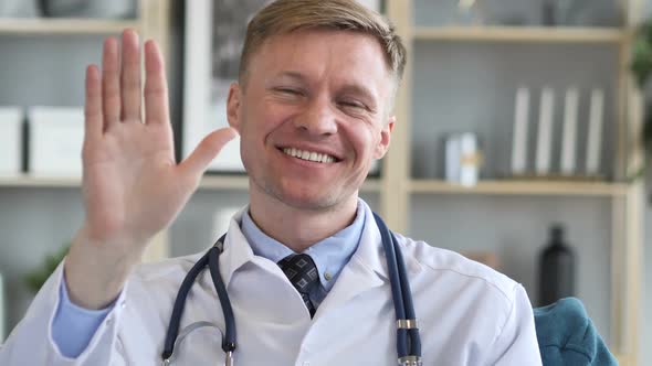 Doctor Waving Hand to Welcome