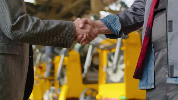 Handshake of Engineer and Factory Worker