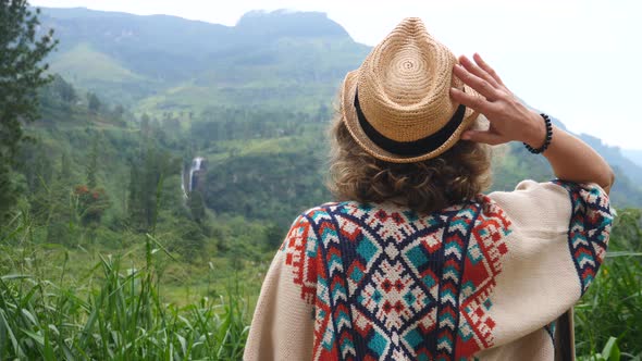 Young Hipster Woman Traveler In Hat Enjoying Green Hills Trekking In Mountains