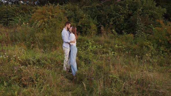 A Beautiful Girl and Boy Hugging in a Park