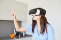 Young woman wearing virtual reality goggles at home. - PhotoDune Item for Sale