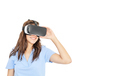 Smiling woman playing with virtual reality goggles isolated on a white background - PhotoDune Item for Sale