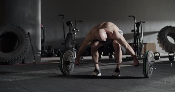 Strong Sportsman in Start Position Before Snatch