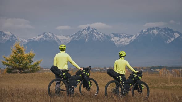 The Man and Woman Travel on Mixed Terrain Cycle Touring with Bikepacking. The Two People Journey