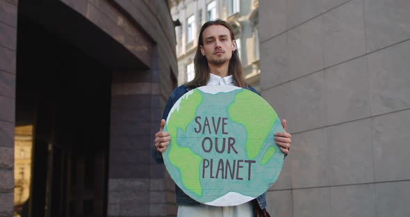 Crop View of Millennial Guy Eco Activist Turning Head and Looking To Camera While Standing at Street