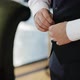Stylish arabic young man in a suit buttoning black jacket. Close up of groom preparing - VideoHive Item for Sale