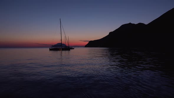 Sailing Boats Anchored in Mediterranean Sea Near Lipari Islands. Colorful Sky, Summer Sunset or