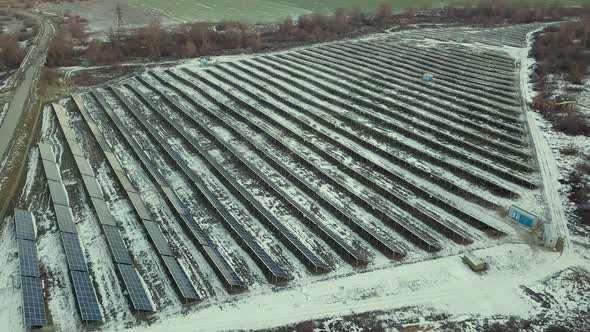 Blue solar photo voltaic panels system producing renewable clean energy in rural area in winter.
