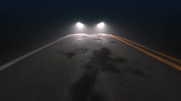 Car with Headlights on Follows Camera Tracking Along Country Night Road