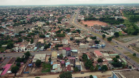 CInematic Circular Motion Aerial View of Lomé, African City Neighborhood roads with Traffic