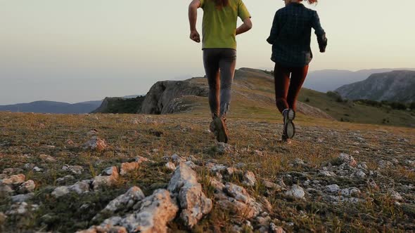 Young Man and Woman Are Jogging in Mountains. Running, Sports, Fitness and Healthy Lifestyle