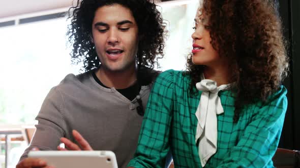 Couple using digital tablet and interacting with each other