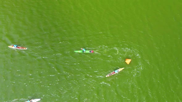 Aerial View of a Sup Boarding Competition on a Pond at Noon on a Summer Day