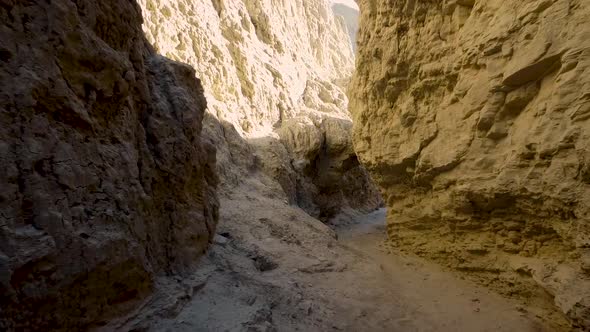 A zoom in drone shot from inside of a desert slot canyon at sunset. All set in the Anza Borrego Dese