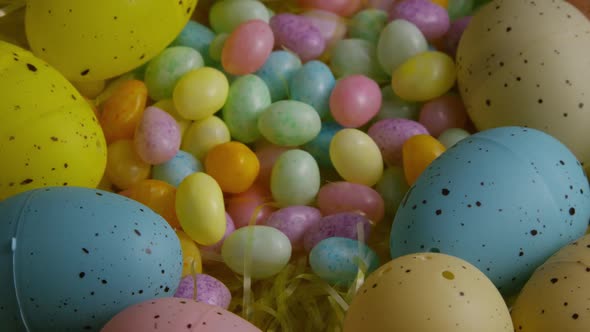 Rotating shot of Easter decorations and candy in colorful Easter grass