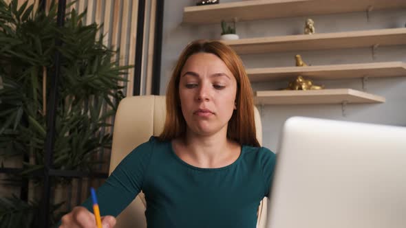 Thoughtful Woman Working on Laptop Computer Looking Away Thinking Solving Problem 