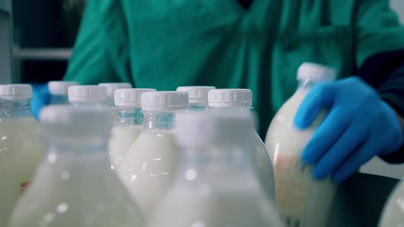 Close Up of Milk Bottles Getting Removed From the Conveyor