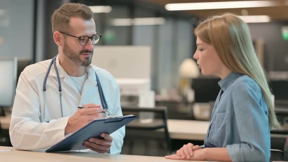 Male Doctor Talking to Female Patient