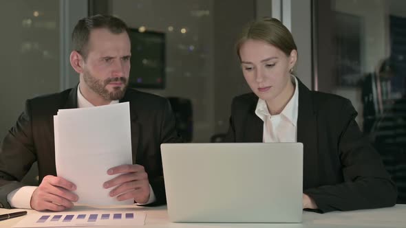 Executive Business People Shocked While Working on Laptop at Night