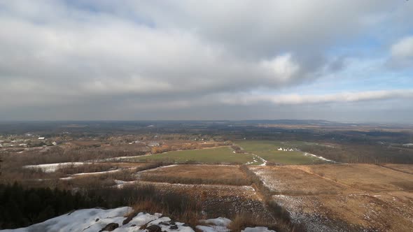 Time lapse of low clouds over rural fields.