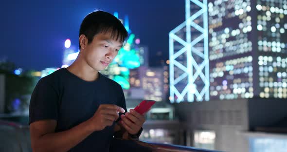 Man Use of Mobile Phone in The Street at Night