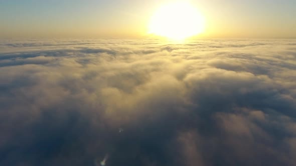 Flying Over the Evening Timelapse Clouds with the Late Sun. Seamlessly Looped Animation. Flight