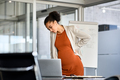 Black pregnant business woman suffering backache at modern office - PhotoDune Item for Sale