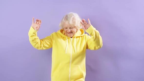 Slow Motion an Elderly Woman Listens To Music and Dances in Studio