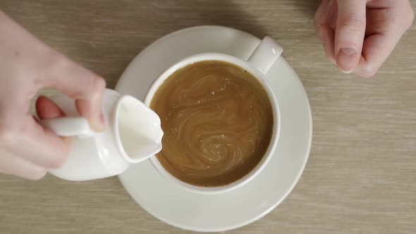 Delicious and Flavored Hot Coffee Rotating in White Cup After It Was Stirred