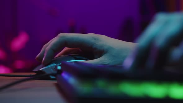 Gamer Typing on Backlight Keyboard Closeup Man Playing Video Game