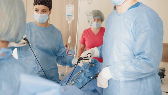 Portrait of Female Medical Worker in Protective Mask and Sterile Gloves Holding