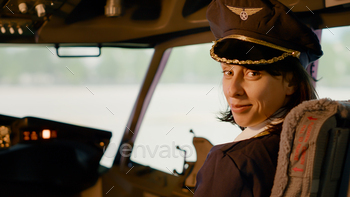 Portrait of female copilot in aviation uniform flying airplane