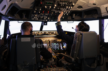 Captain and female copilot getting ready to fly plane