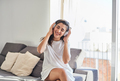 Happy young woman listening to music at home - PhotoDune Item for Sale
