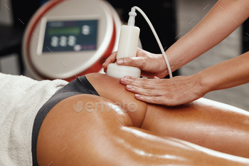 lite massage at the beauty salon. She have an ultrasound cavitacion treatment to fat reduction.