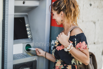 hdrawing cash at ATM machine.