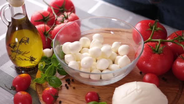 Mozzarella Cheese Small Balls Falling Into Glass Bowl