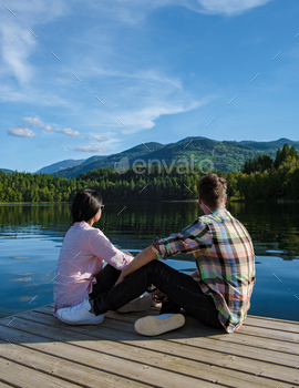 sh Columbia Canada in BC. couple of men and women on a wooden pier by the lake in Canada BC