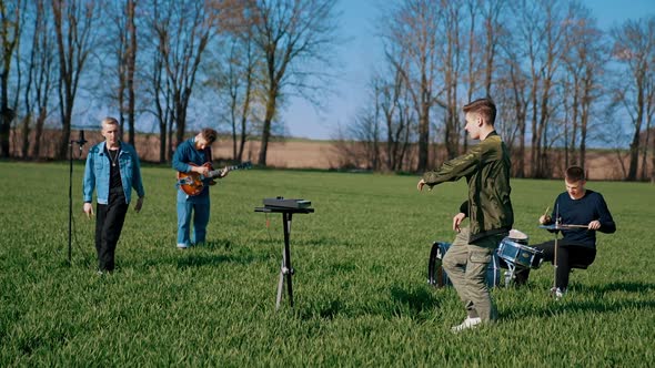 Young band play musical instruments on field