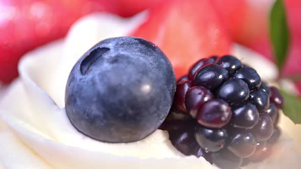 Composition of Ripe Genuine Black and Red Berries on White Fluffy Whipped Cream Extreme Closeup