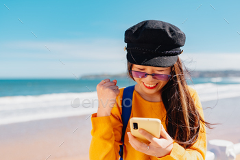 ne with her hand making the peace sign or victory sign while sightseeing in a European city