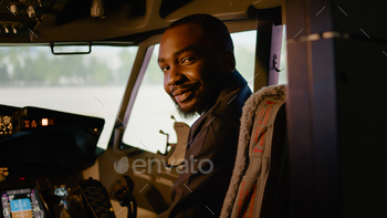 Portrait of african american copilot sitting in airplane cockpit