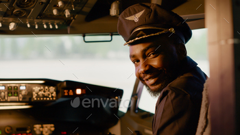 Portrait of african american copilot helping to fly airplane