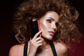 Beautiful woman handling phon. Bright makeup and beautiful hairstyle - PhotoDune Item for Sale
