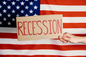 banking system and world economic crisis, Female hand hold cardboard with word Recession against national american flag
